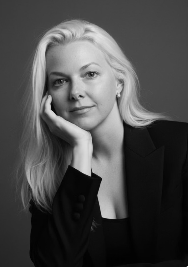 Tammy Kling in a dark blazer, resting her chin on her hand.